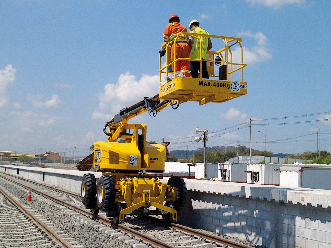 RR 9/200 rail-road aerial lift in action, lifting workers for maintenance on railway infrastructure.