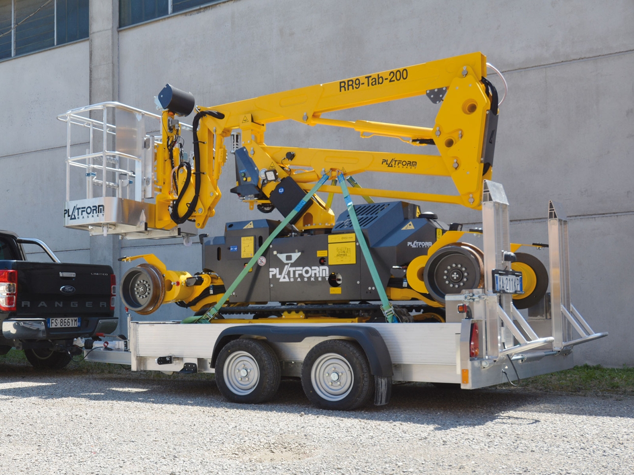 RR 9/200 rail-road aerial lift secured on a trailer for easy transport to job sites.