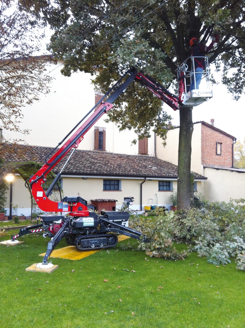 Spider 13.65 lift deployed in a residential area for tree maintenance.