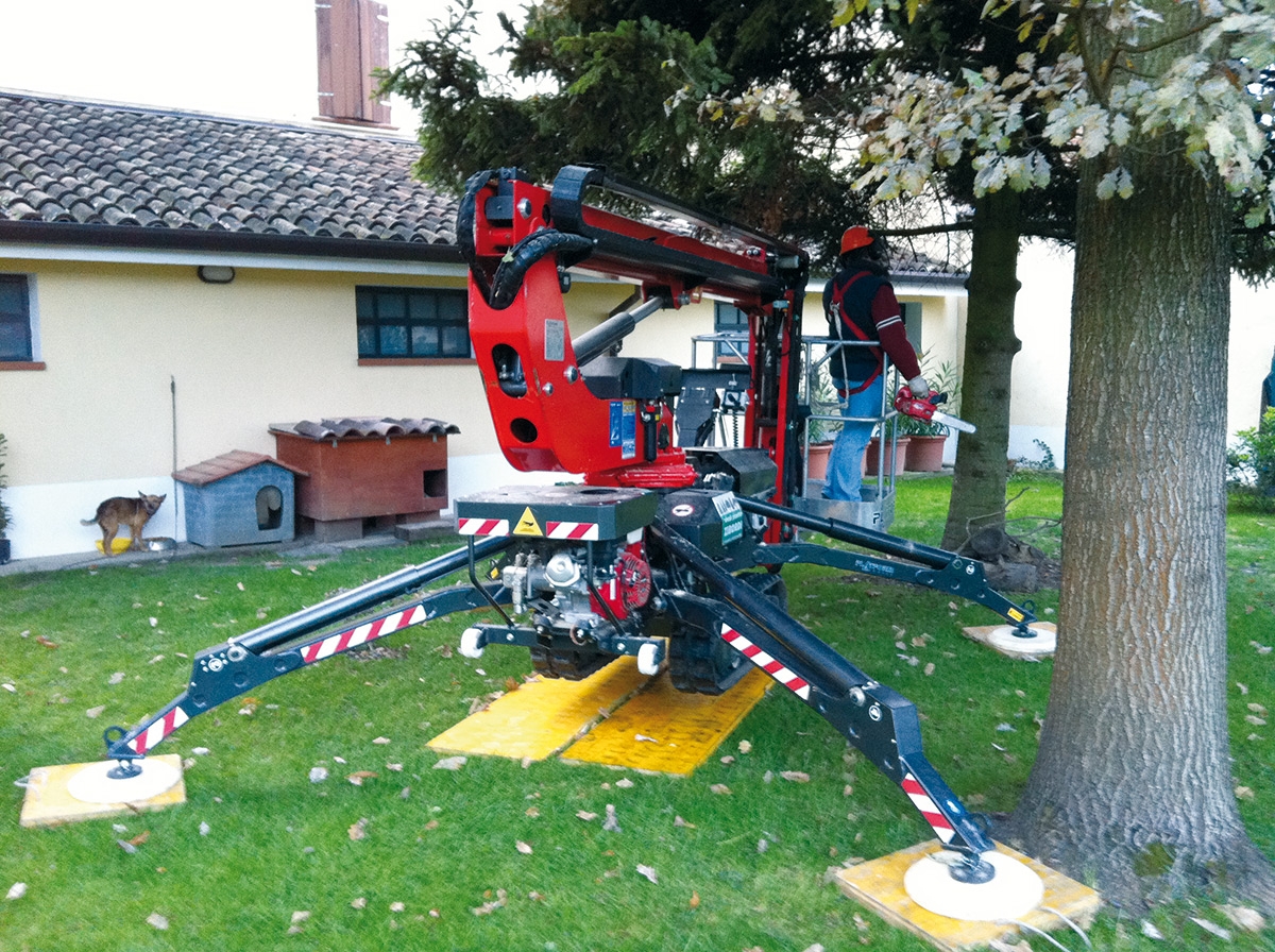 Spider 13.65 lift in use for elevated work in a garden setting.