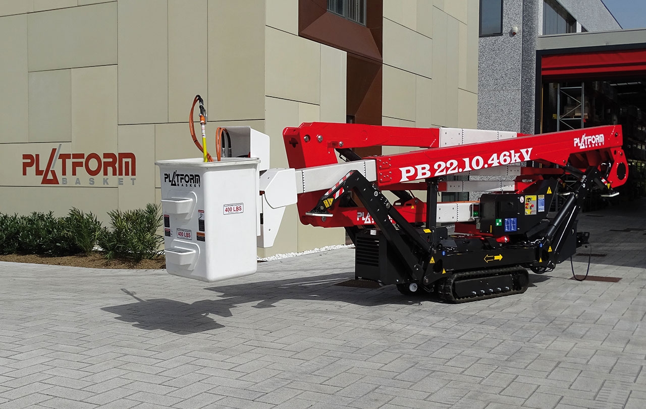 Spider lift positioned near a building for access.