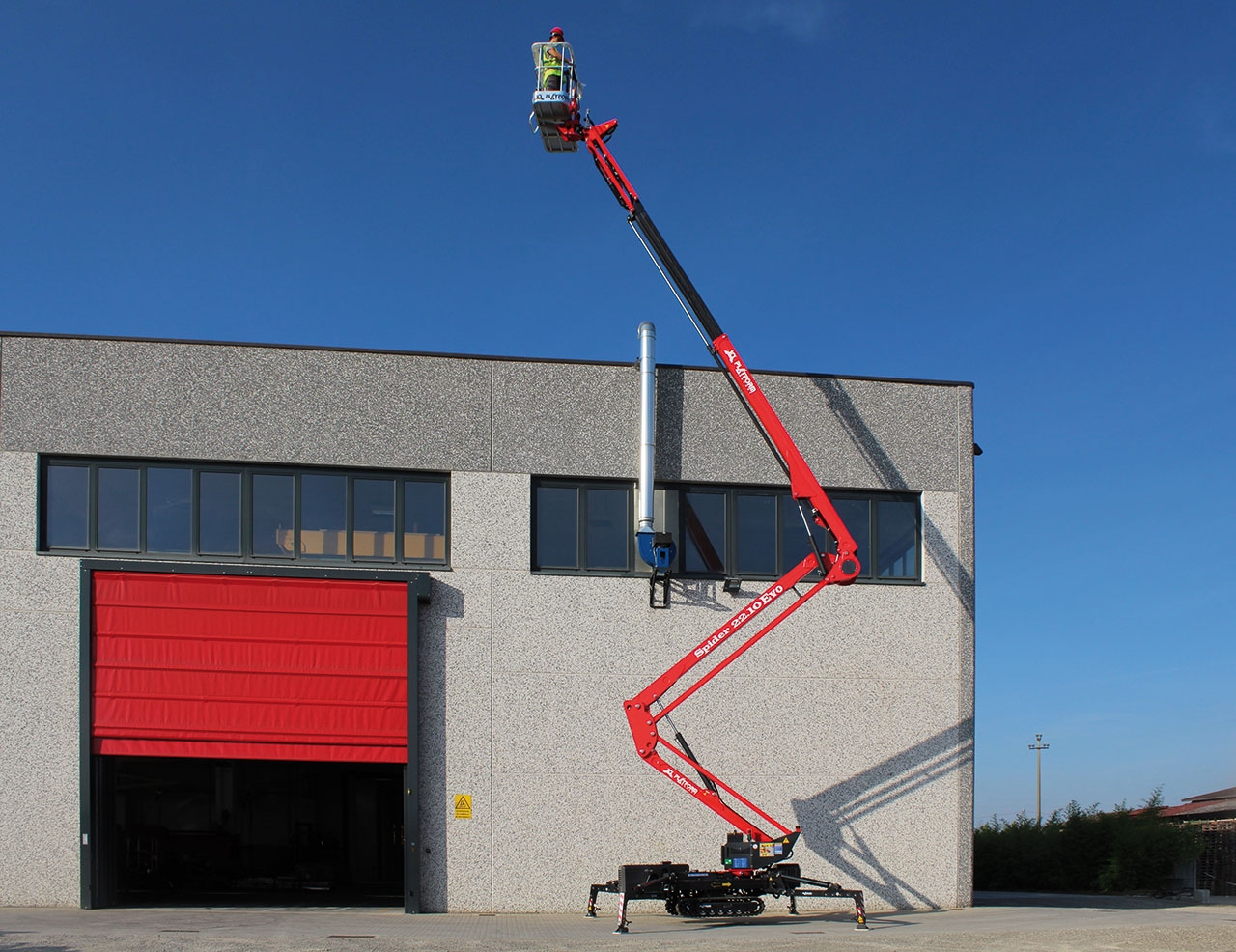 Spider lift extended to access a high area on a building