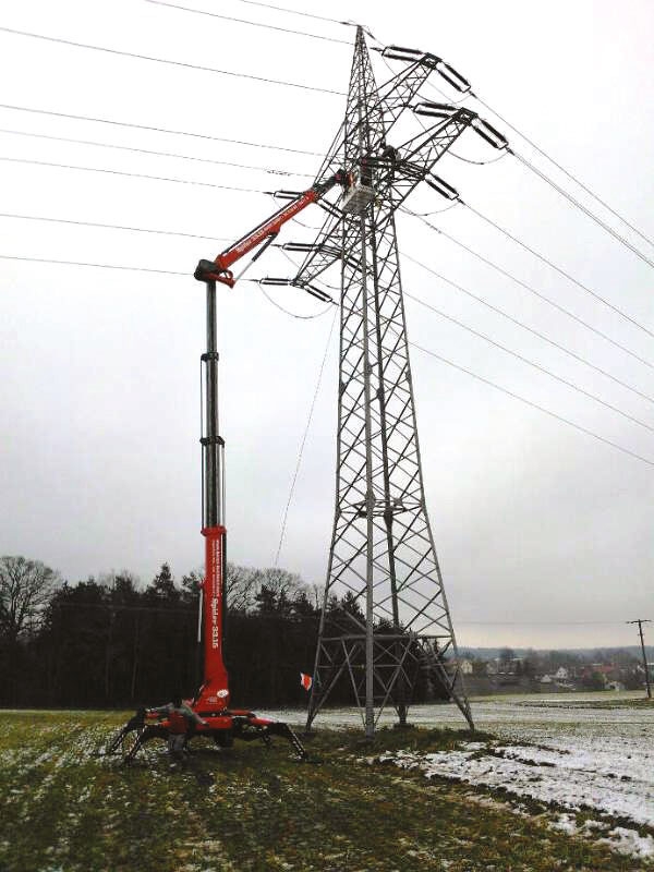 Lift extended for high-voltage power line maintenance.