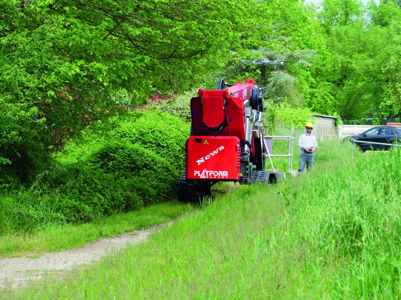 Self-propelled lift navigating through a forested worksite.