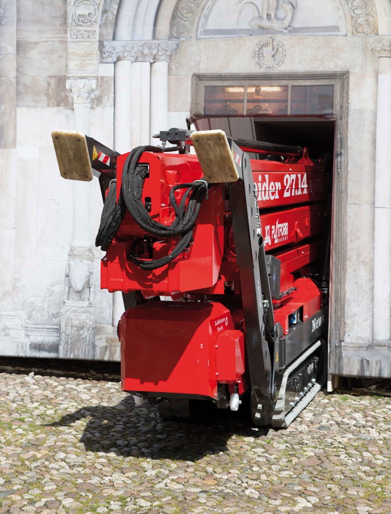 Narrow spider lift maneuvering through a doorway.